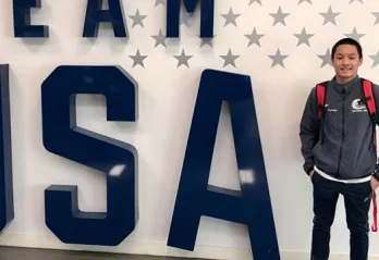 Steven in front of Team USA sign