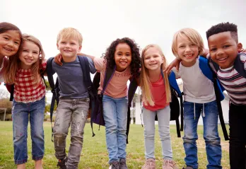 Young kids wearing backpacks