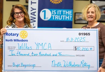 Caroline Whitson and Jenny Richardson presenting check