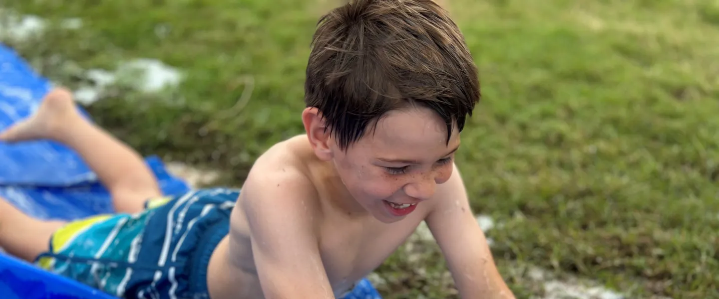 Boy on slip n slide