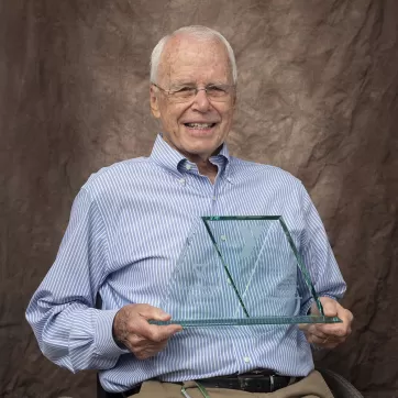 Darle Shouse holding his Red Triangle award