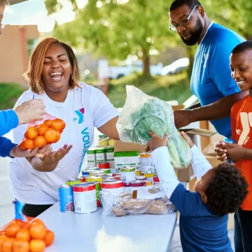 People handing food out to a family