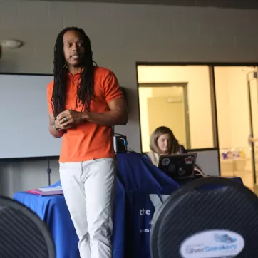 Man presenting to a group of teens