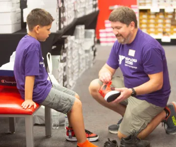 Boy trying on new shoes