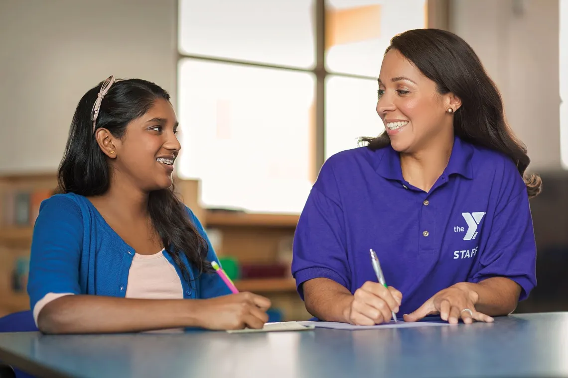 YMCA employee teaching student