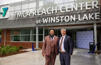 kenneth pettigrew and darryl head infront of newly opened YMCA REACH Center at Winston Lake