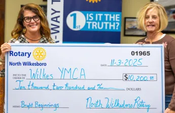 Caroline Whitson and Jenny Richardson presenting check