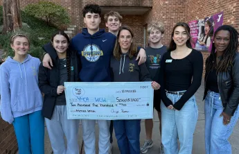 Stroll into Light presenting check to WGW