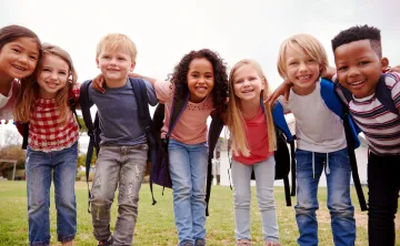 Young kids wearing backpacks