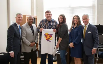 Teenager holding up a tshirt