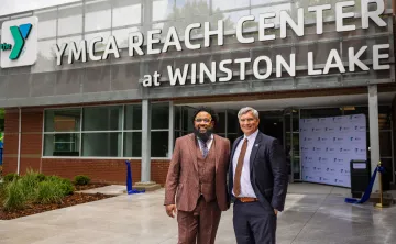kenneth pettigrew and darryl head infront of newly opened YMCA REACH Center at Winston Lake